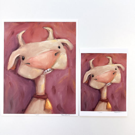 two different print sizes showing for this white cow with horns and a bell collar.