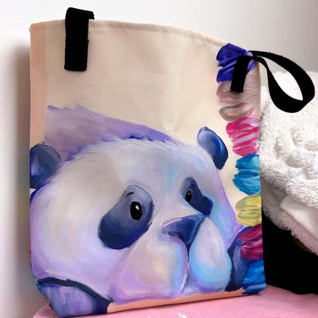 Close up image of tote bag with purple panda staring at the stack of macarons.
