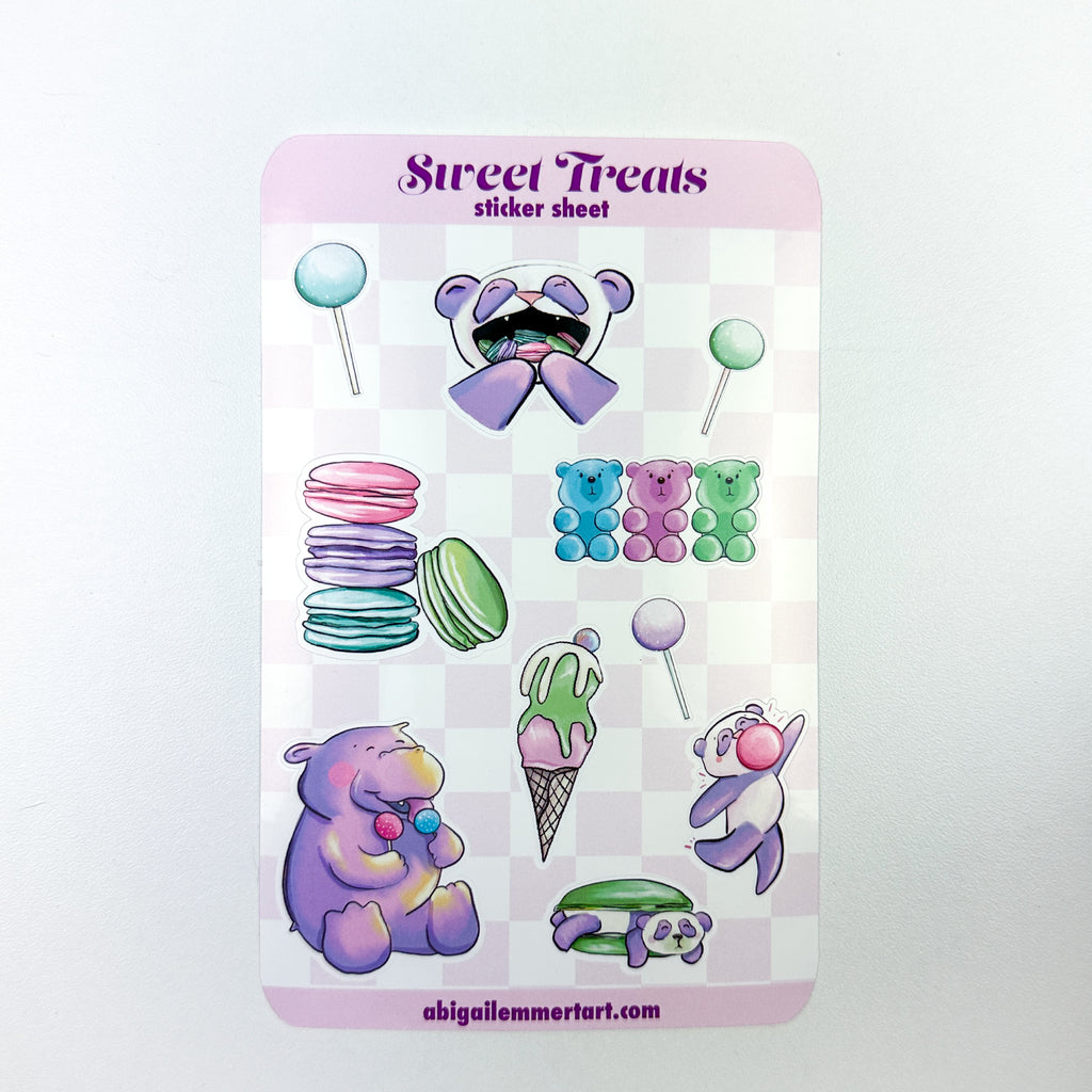 A sticker sheet with 3 cake pops, a stack of macaron, the panda with mouthful of macarons, hippo with cake pops, ice cream, panda macaron sandwich , dancing bubble gum panda and gummy bears.