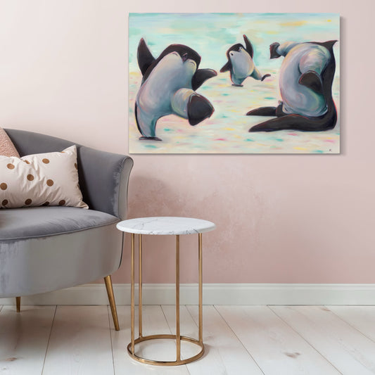 Painting of penguins on a wall above a sofa and side table in a living room.