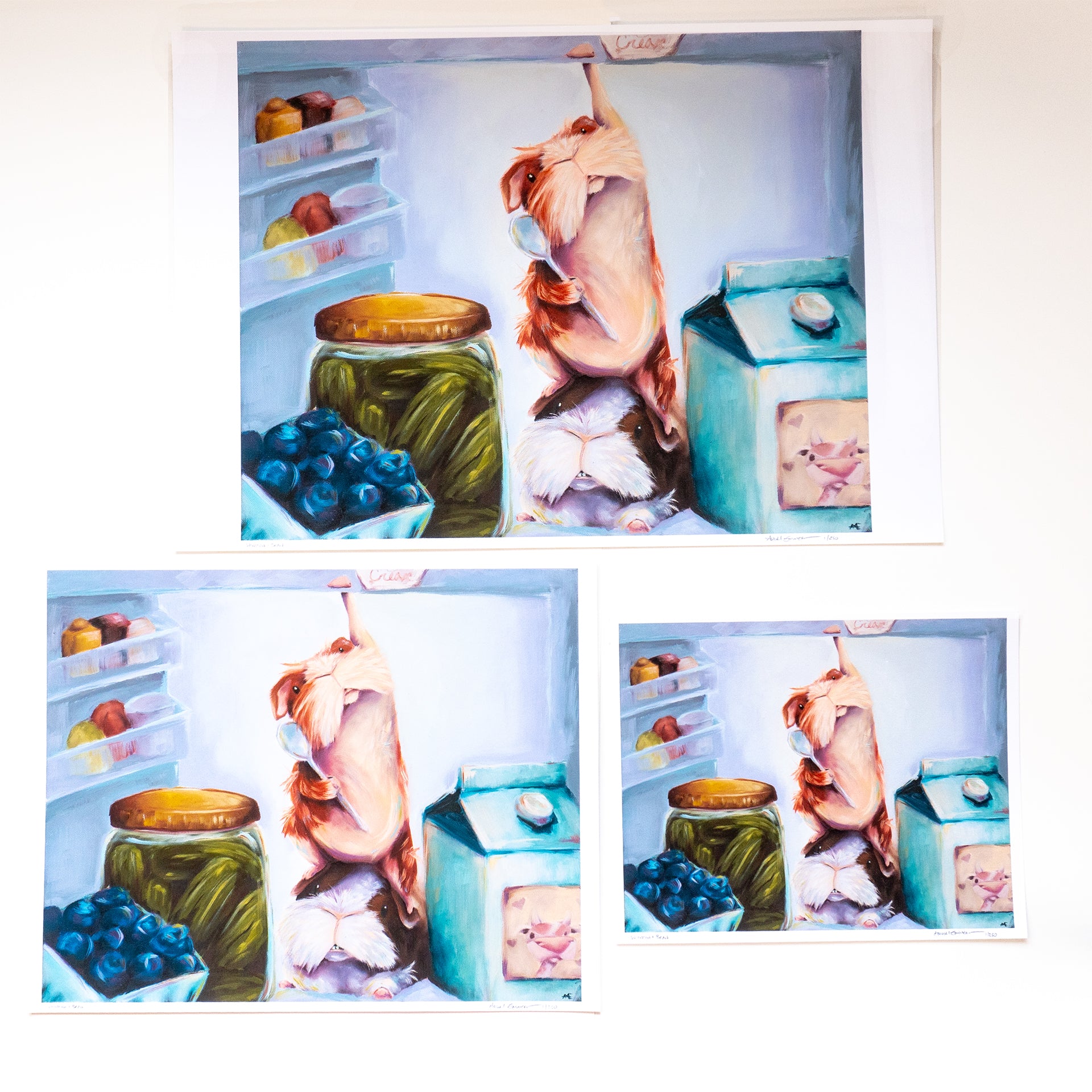 3 DIFFERENT SIZE COMPARISON OF FINHE ART PRINT OF 2 GUINEA PIGS IN A FRIDGE, ONE IS REACHING FOR THE ICE CREAM. 