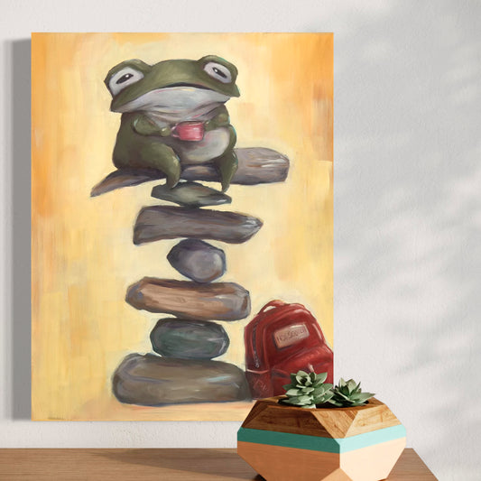  artwork of a frog balancing on stones against a yellow background, with a plant in the foreground.