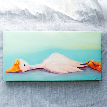 canvas reproduction of a white goose laying down on a textured backdrop. 