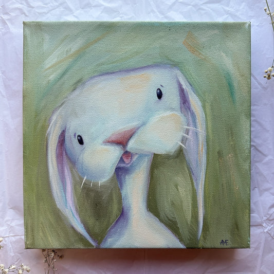 Bianca is a white bunny oil painting with beautiful subtle colors of purples and golds laced throughout her fur.  She sits on a pastel green background