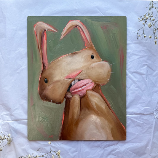 Oil painting of a tan bunny shoving a pink macaron in her mouth. She has pink highlights around her and a vintage type green background. 