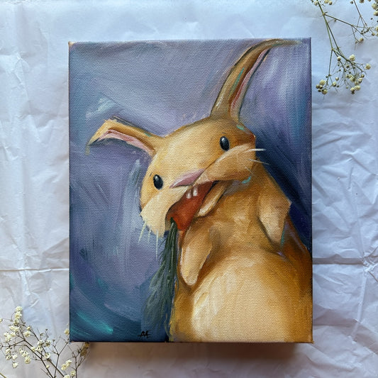 is a tan bunny oil painting with an orange carrot in his mouth and a purple background.