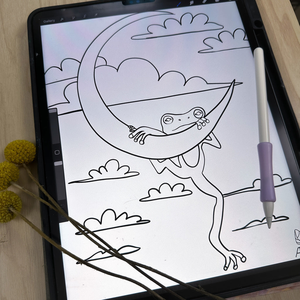 iPad with app procreate open and showing the digital coloring page of the frog hanging on the moon. Photo is from an angle this time. 