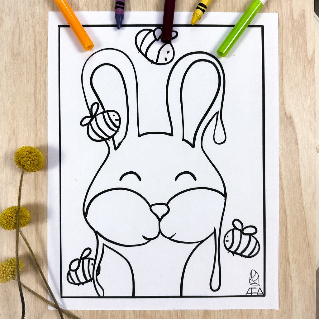 Coloring page of a bunny facing the front of the page with tall standing up ears. There are 4 bumble bees surrounding the honey. The honey has drips coming off of it because it's a Honey Bunny. 